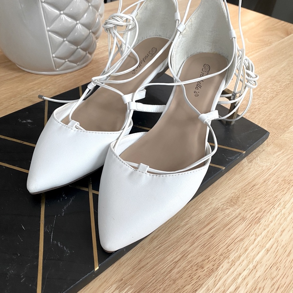 Breckelle’s white pointed flats, wrap up ankle